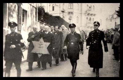 Jews being forced to walk with the star of David during the Kristallnacht in Nazi-Germany on the night of 9-10 November, 1938. See page for author [public domain], via Wikimedia Commons.